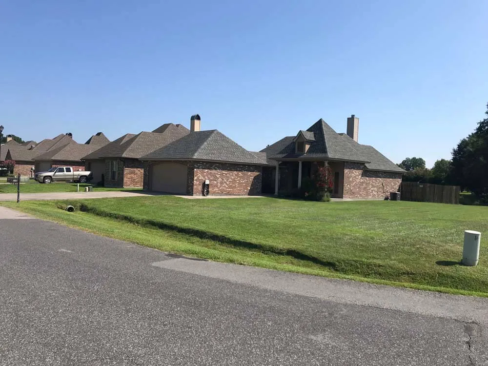 Lawn care result, mowed front lawns along a residential street