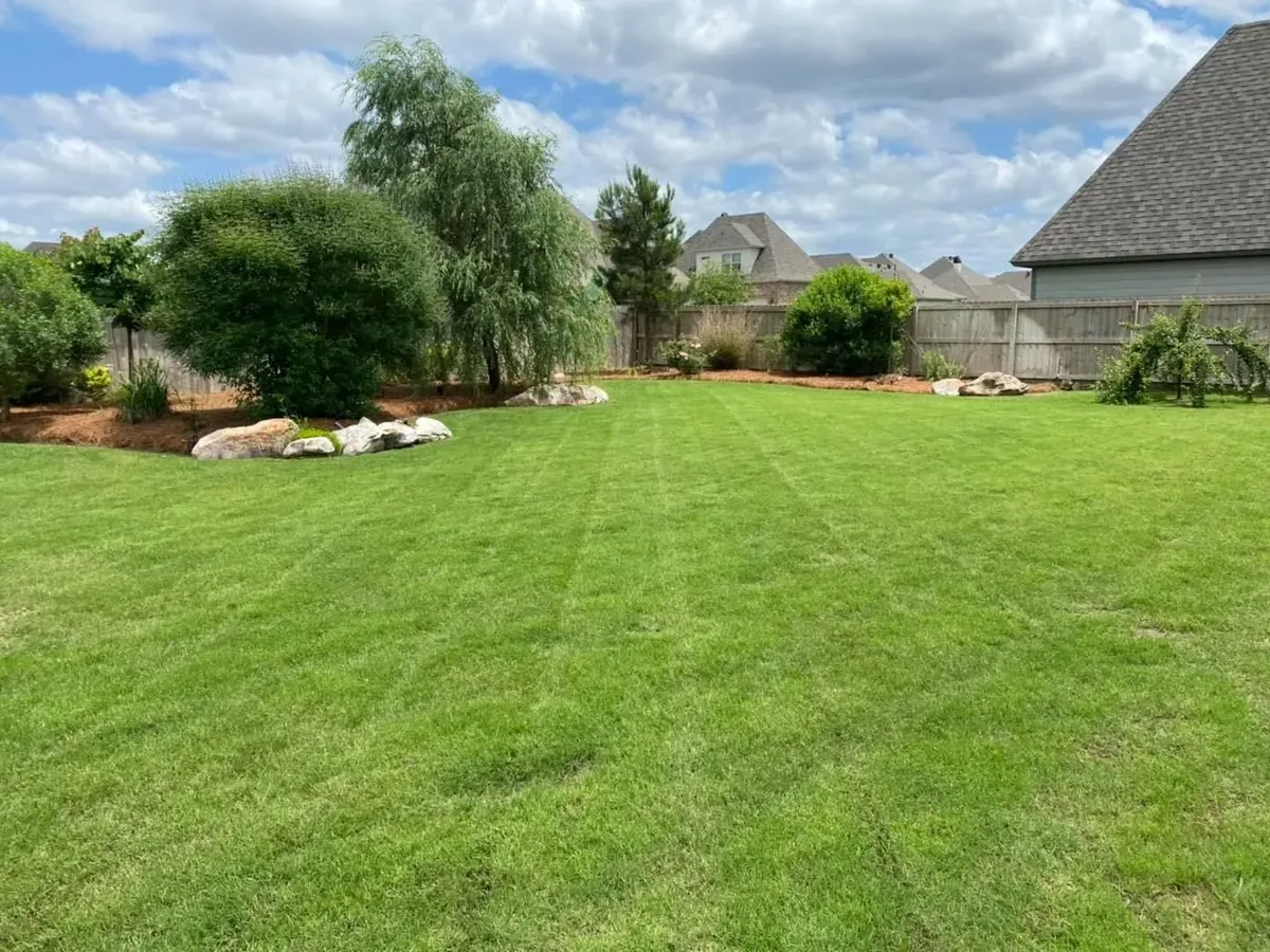 A striped, freshly cut lawn on a lawn maintenance visit